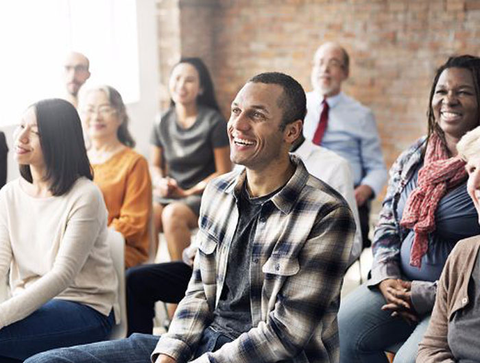 Diverse group of people enjoying a laugh at a seminar