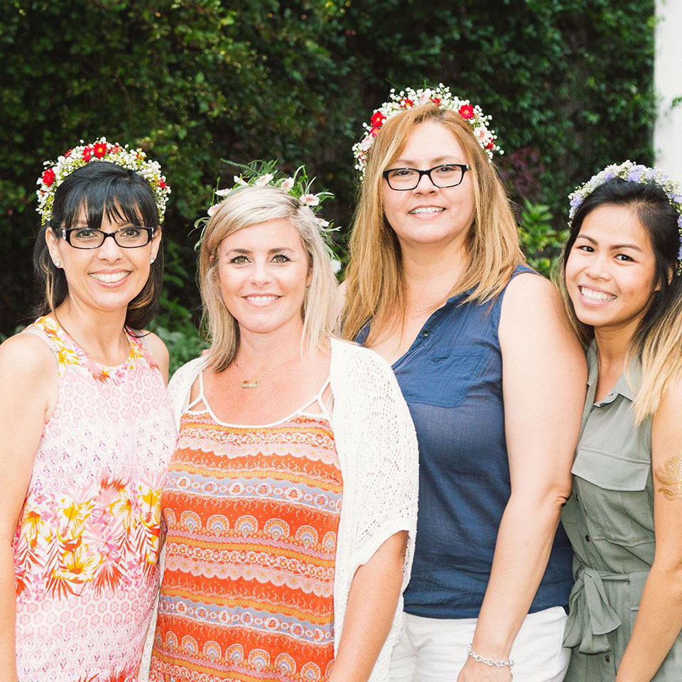 Group of women who work for Rexford with flower crowns