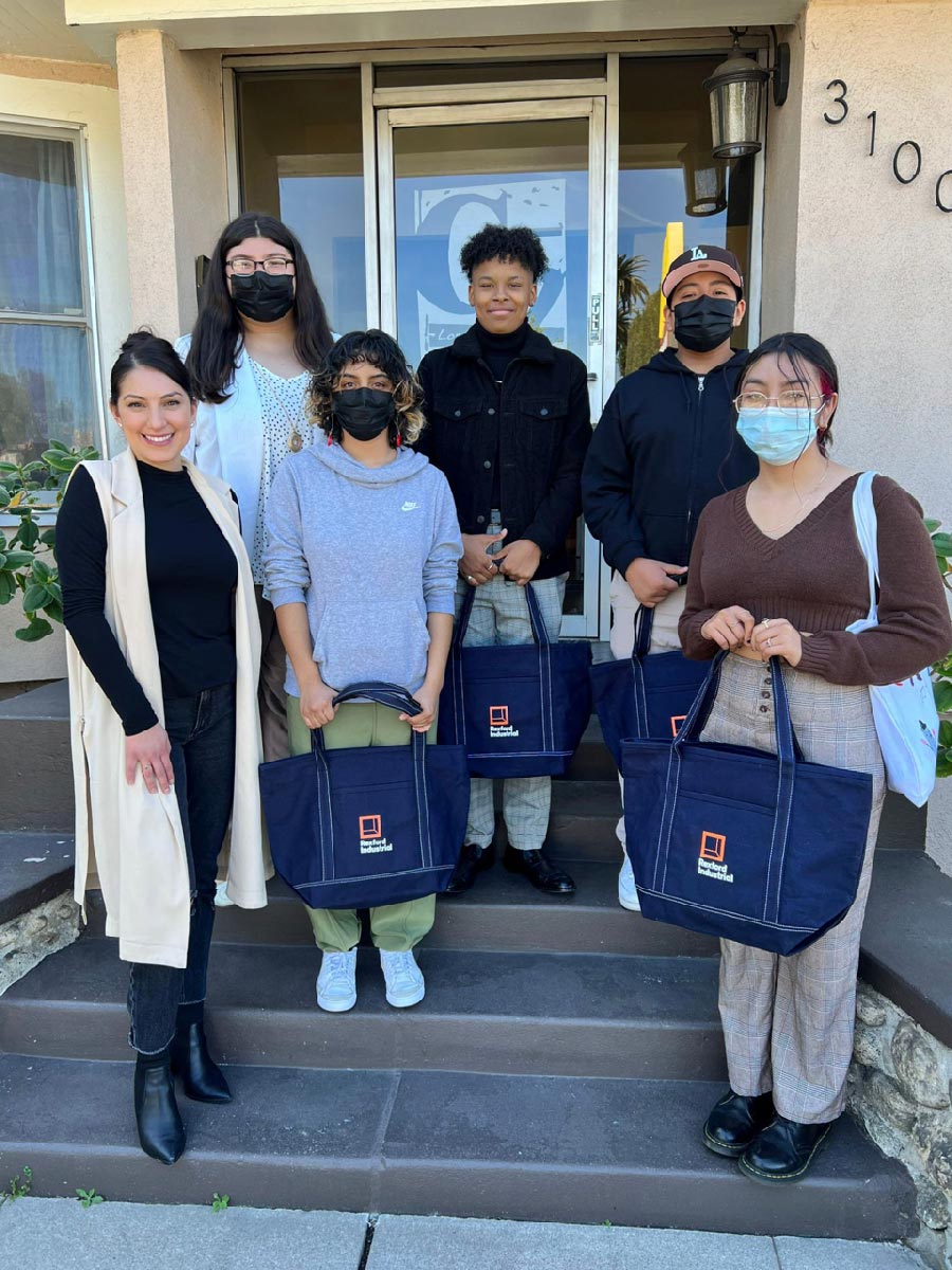 A group of young people with Rexford totes