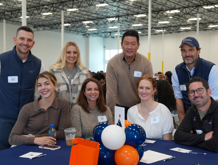 Group of Rexford employees at an internal event inside a warehouse
